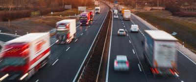 Trucks driving on divided highway bg