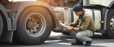 Technician inspecting truck tires