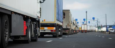 line of trucks on highway bg