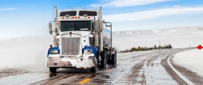 truck driving on snow covered road