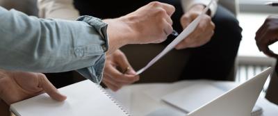 two people writing on paper