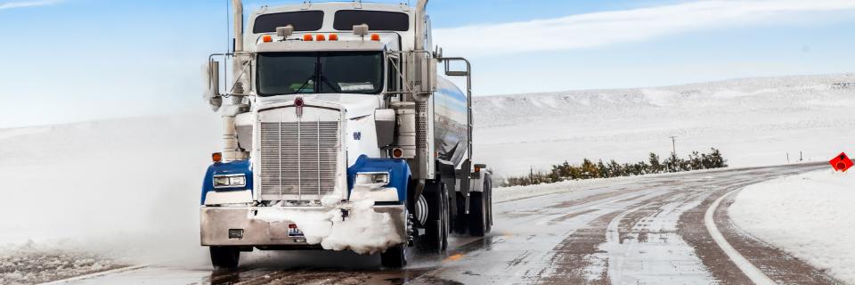 truck driving on snow covered road