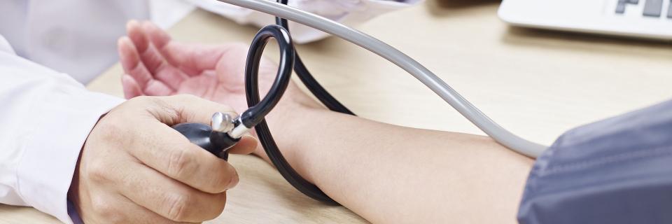 person receiving a blood pressure test bg