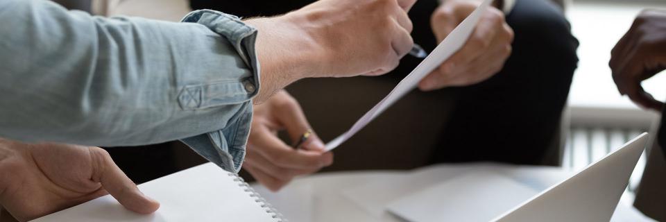 two people writing on paper